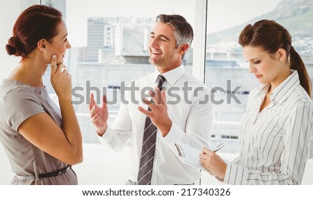 Businessman discussing work with co-workers in the office