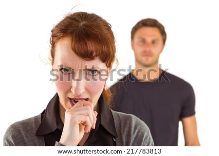Worried woman with man behind on white background
