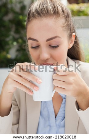 Beautiful businesswoman enjoying a coffee outside at the coffee shop