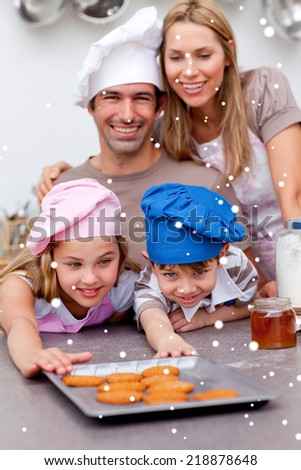 Family eating cookies after baking with snow falling