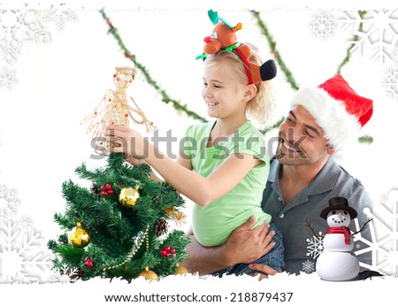 Cute little girl decorating the christmas tree with her father against christmas themed frame