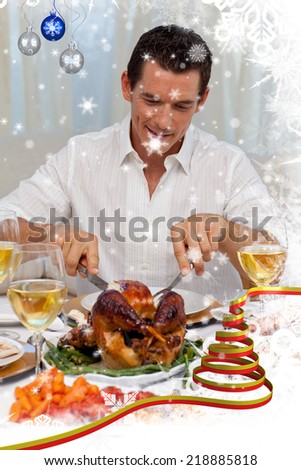 Attractive man eating turkey in Christmas dinner against snow falling
