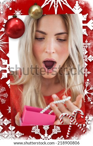 Composite image of Shocked woman discovering necklace in a gift box in a christmas themed page