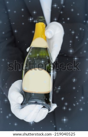 Close view of open bottle of champagne against twinkling stars