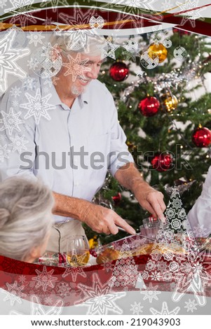 Grandfather carving turkey at christmas against christmas frame