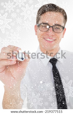 Nerdy businessman writing with black marker against snowflakes on silver