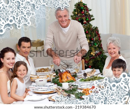 Grandfather cutting turkey for Christmas dinner against snowflake frame