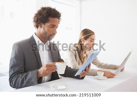 Business people having coffee on their break at the coffee shop