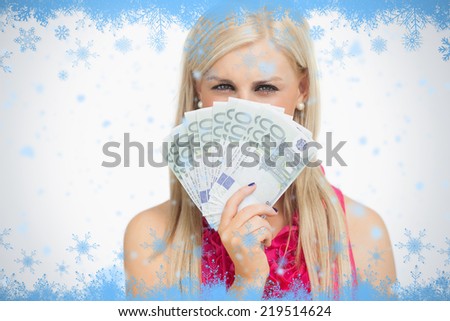 Beauty holding 100 euros banknotes against snow flake frame in blue