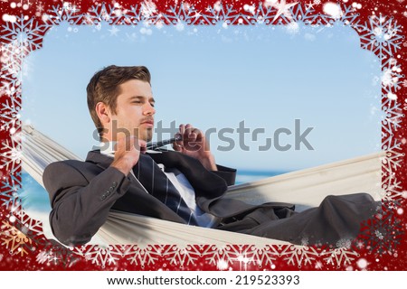 Composite image of snow frame against businessman man lying in hamock taking off his tie