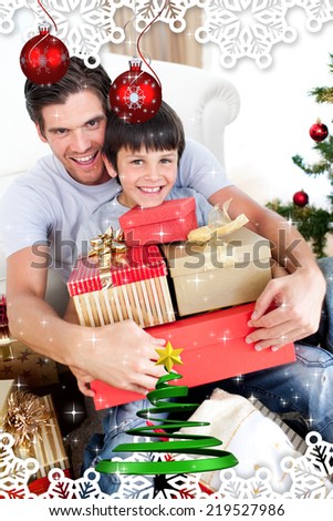 Happy father and son holding Christmas presents against twinkling stars