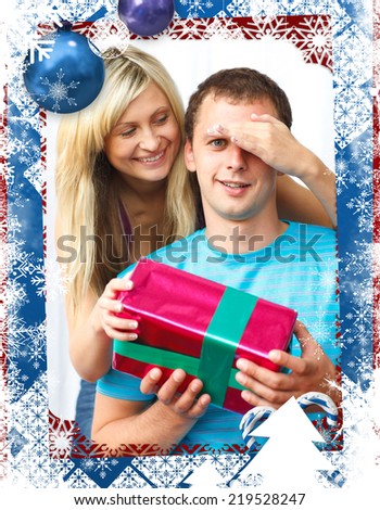 Woman giving a present to her boyfriend against christmas themed frame