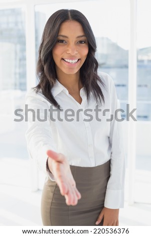 Businesswoman offering a friendly handshake at work