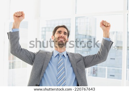 Businessman celebrating a good job in his office