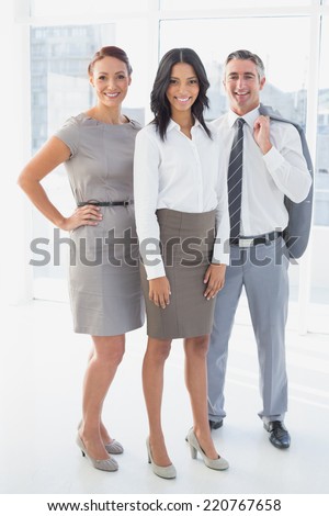 Businesswoman smiling while at work with co-workers