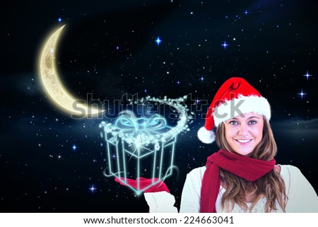 Festive blonde presenting with hand against crescent moon in the night sky
