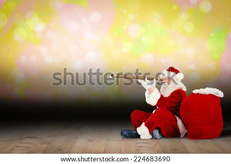 Santa claus looking through telescope against shimmering light design over boards