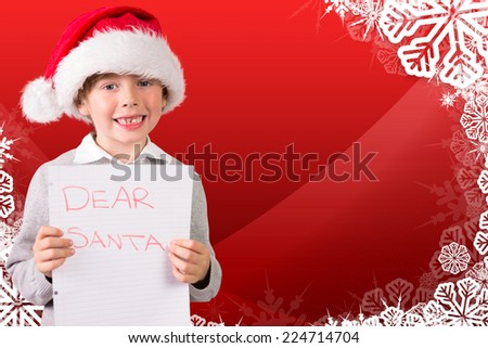 Festive boy showing letter against christmas themed snow flake frame