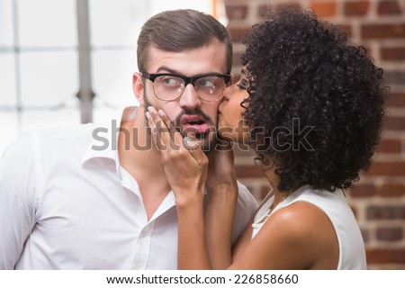 Close up of young woman kissing man in the office