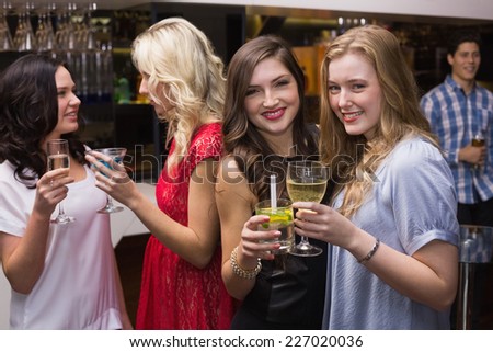 Pretty friends having a drink together at the bar