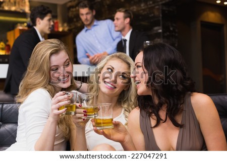 Pretty friends having a drink together at the bar