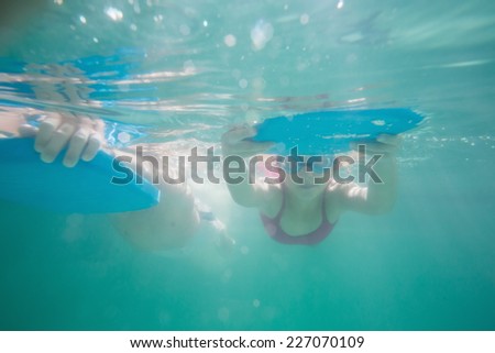 Cute kids swimming underwater in pool at the leisure center