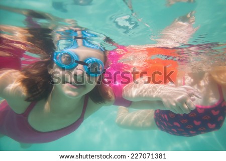 Cute kids posing underwater in pool at the leisure center