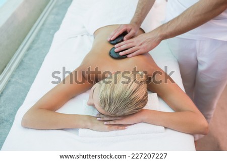 High angle view of a beautiful young woman receiving stone massage at health farm