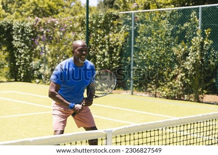 Image, Stock Photo Senior man playing tennis in gym