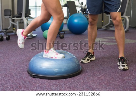 Low section of fit couple exercising at the gym