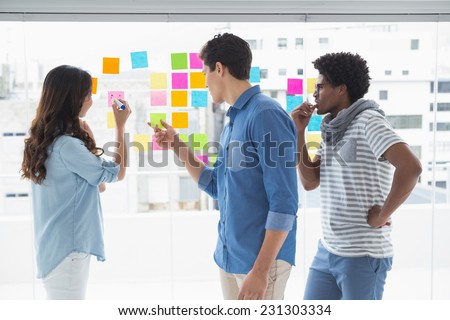Young creative team brainstorming together in creative office