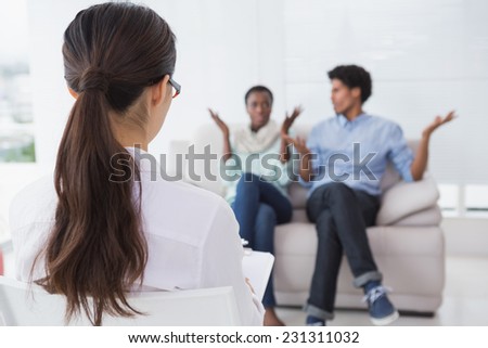 Couple talking with their therapist in therapists office
