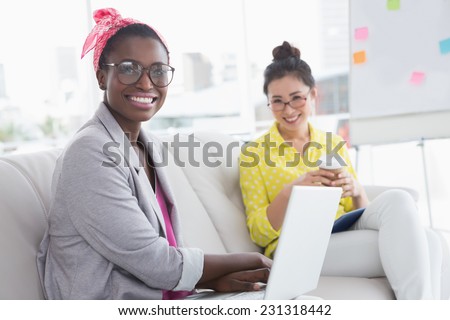 Young creative women on the couch in creative office