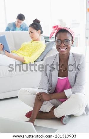 Young creative woman working on floor in creative office