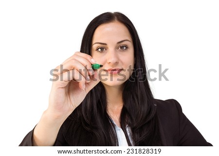 Pretty businesswoman writing with marker on white background