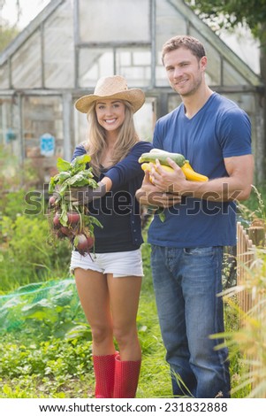 Cute couple gardening on sunny day at home in the garden