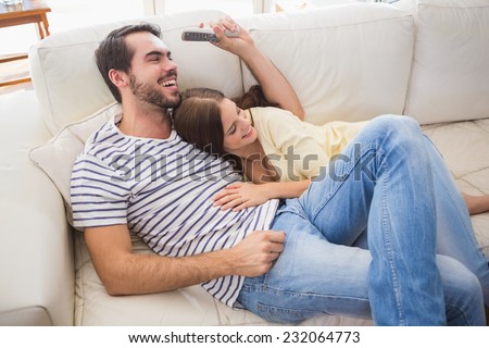 Cute couple relaxing on couch at home in the living room