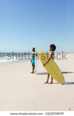 Similar – Image, Stock Photo Female surfer standing at the beach with surfboard