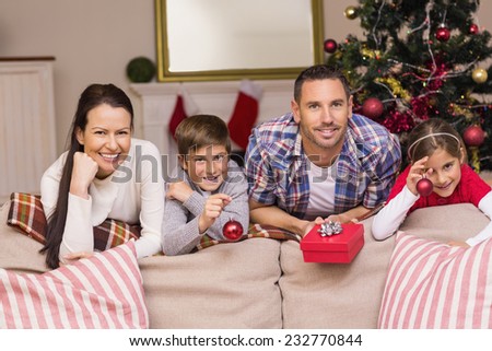 Happy family leaning on the couch at home in the living room