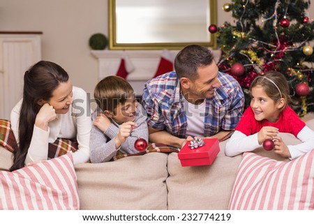 Smiling family leaning on the couch at home in the living room