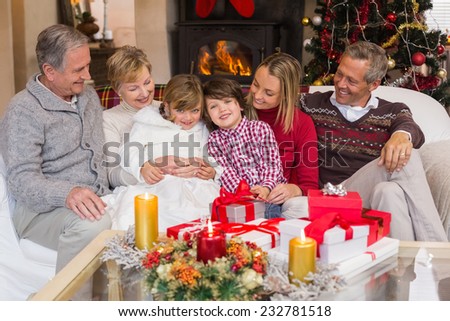 Multi generation family sitting on a couch during christmas at home in the living room