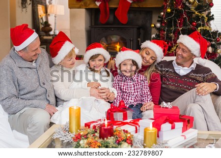 Multi generation family sitting on a couch during christmas at home in the living room
