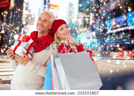 Happy festive couple with gifts and bags against blurry new york street