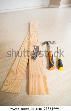 Tools of the building trade on wooden floor