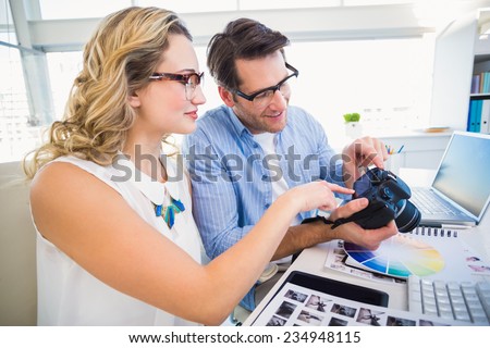 Photo editors looking at camera in office