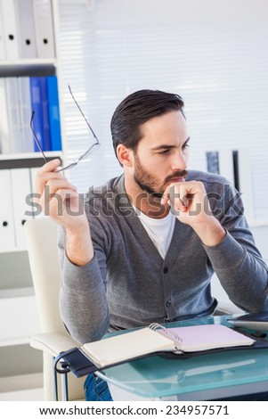 young businessman organizing his schedule at his desk in the office