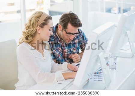 Photo editors working on contact sheet in office