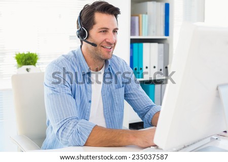 Photo editor talking with headphone in office