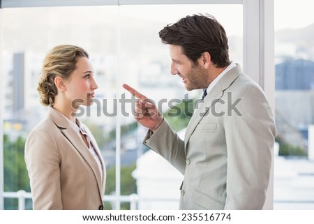 Angry man pointing at his colleague in office
