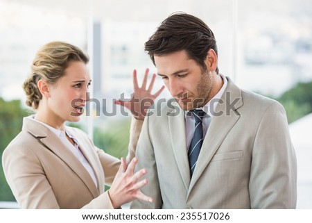 Woman shouting at male colleague in office